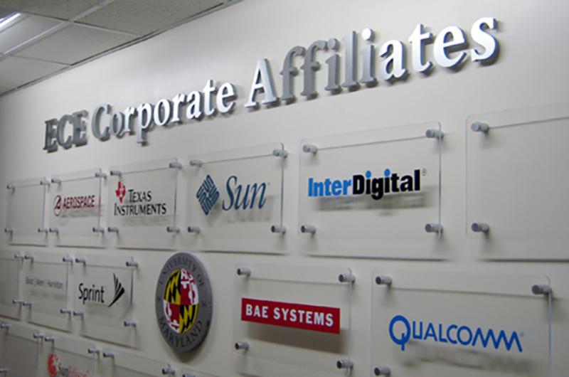 Photograph of wall displaying various dimensional logos